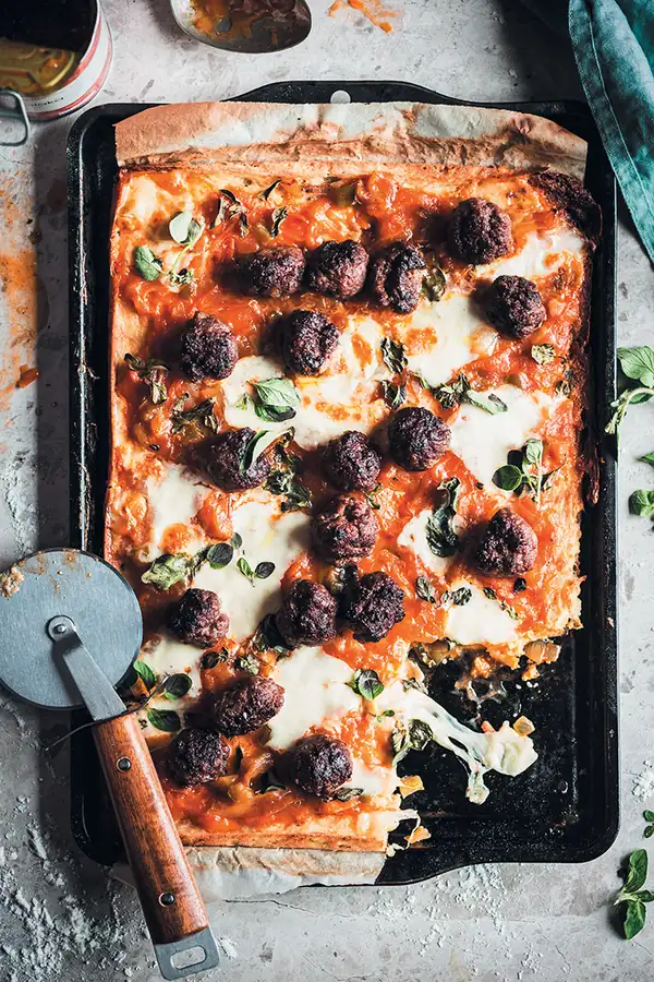 Mealie meal pizza with spicy chakalaka and boerewors meatballs
