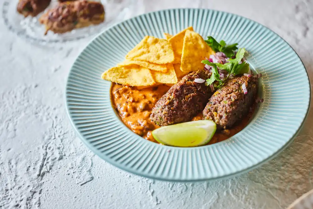 Mexican black bean stew with avocado beef roulade