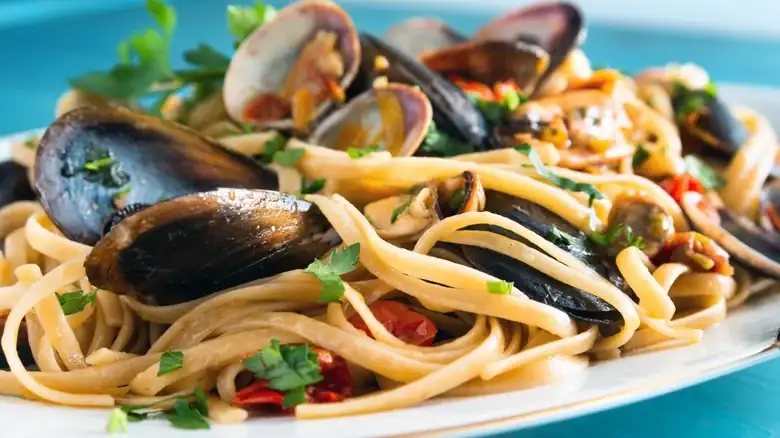 For pasta with seafood, a light tomato and white wine sauce works very well.