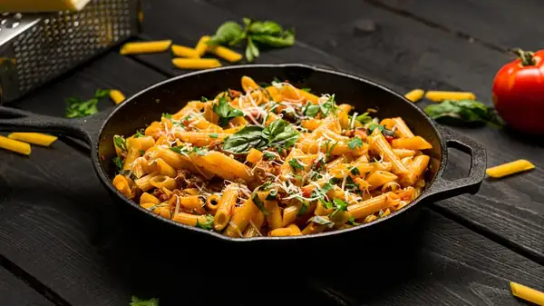 When is it appropriate to cook pasta directly in the sauce, and when is it not?