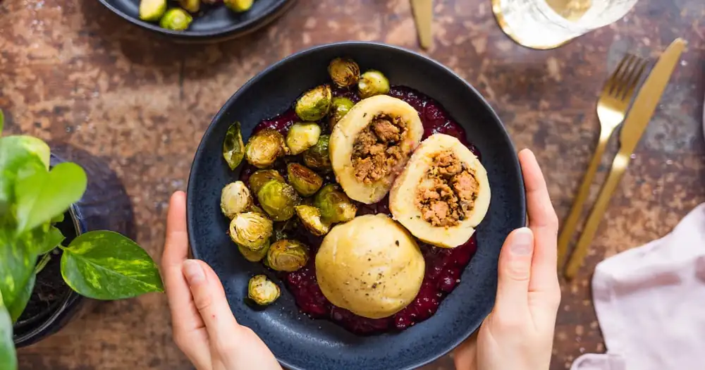 Vegan stuffed dumplings with Brussels sprouts and cranberry sauce