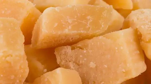 What are the crunchy crystals that appear on some aged cheeses?