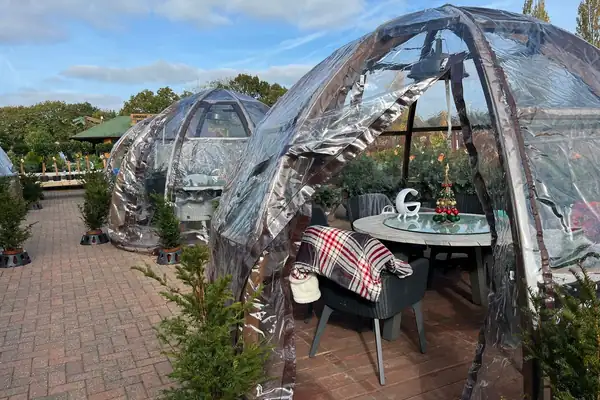 Winter wonderland garden centre opening dining globes at festive food market