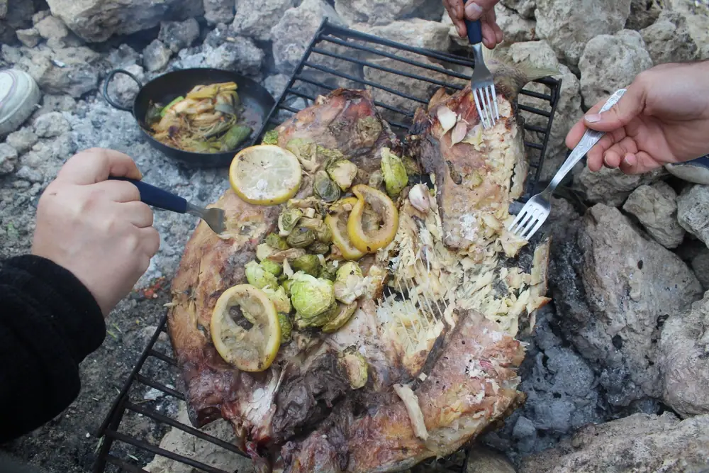 Pescado entero a la parrilla relleno de coles de Bruselas y limón.