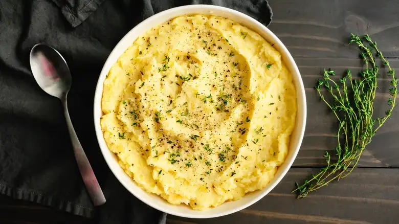 A mashed potato dish reminiscent of French fries with sour cream and onions