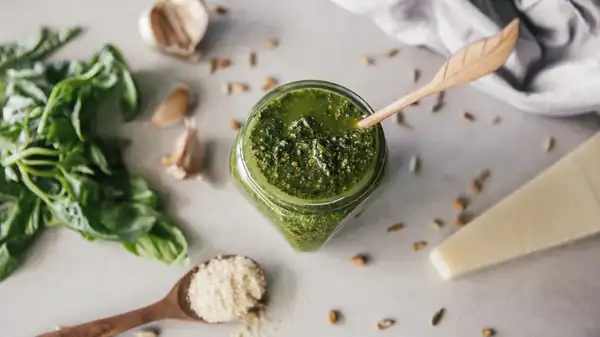 Blanching the basil preserves the bright green color of the pesto, but reduces its flavor.