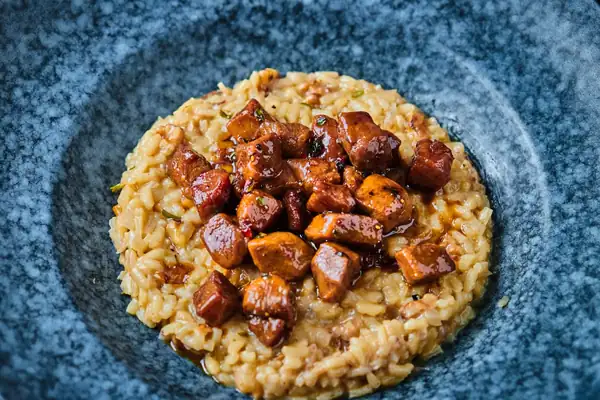 Walnut risotto with roasted, honeyed duck breast cubes