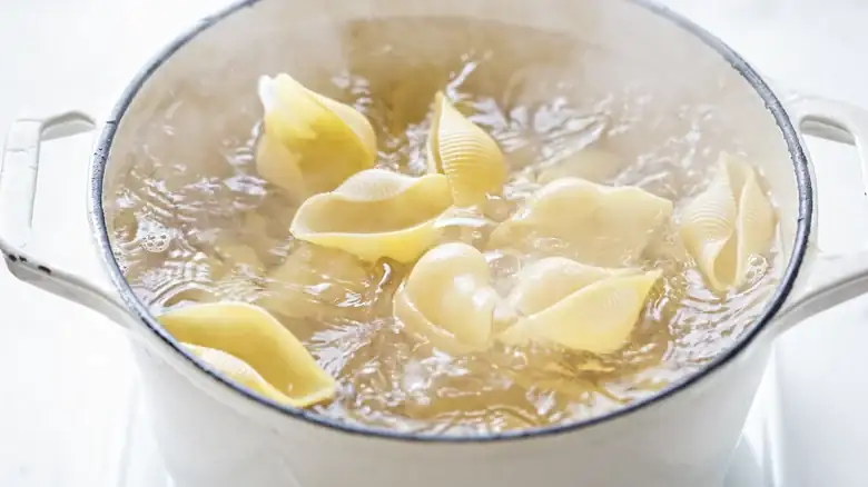 Prevent the pasta water from boiling over by using a large pot