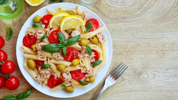 Dressing the pasta while it's hot gives the salad more flavor