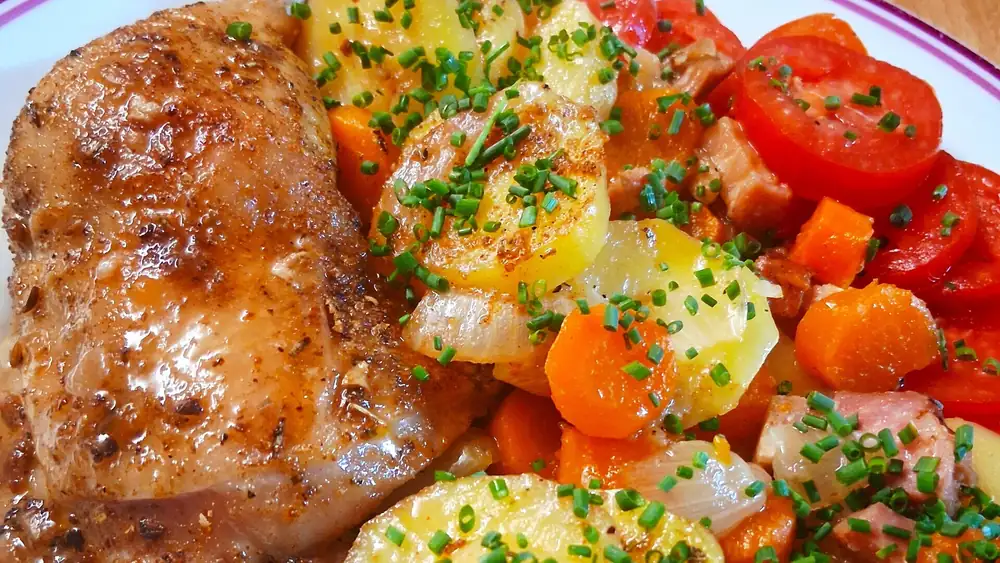 Chicken thighs baked in bacon with potatoes and carrots