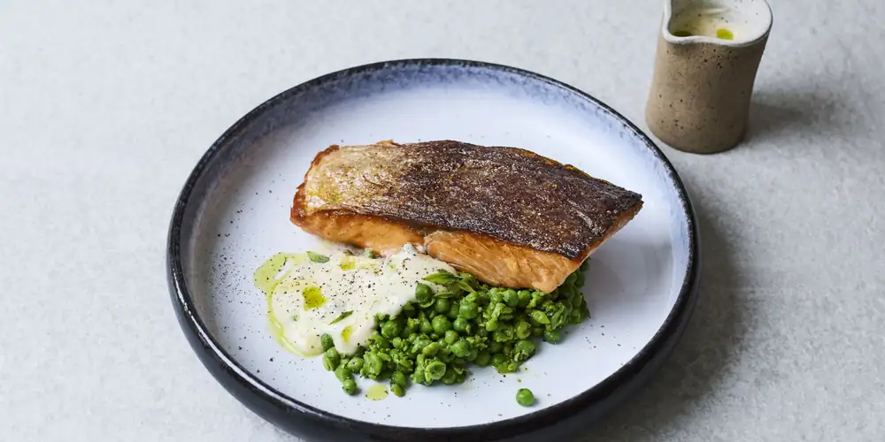 Receta de salmón crujiente con beurre blanc, guisantes triturados y aceite de perejil