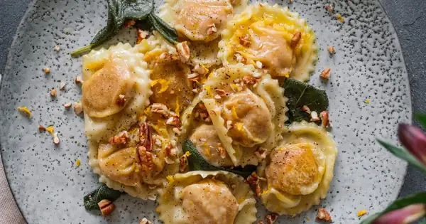 Vegan pumpkin ravioli in sage butter with pecans