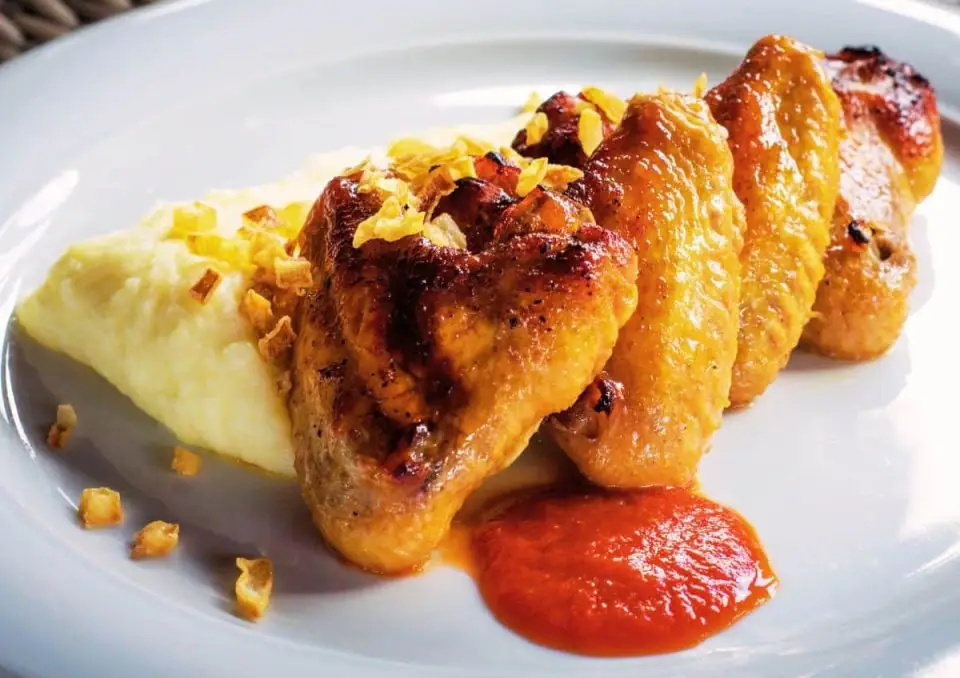 Alitas de pollo con cerveza negra, puré de patatas y salsa de tomate picante