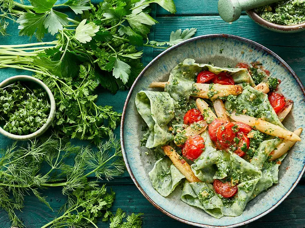 Spinach pappardelle with asparagus and garden herb pesto