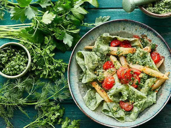 Spinach pappardelle with asparagus and garden herb pesto