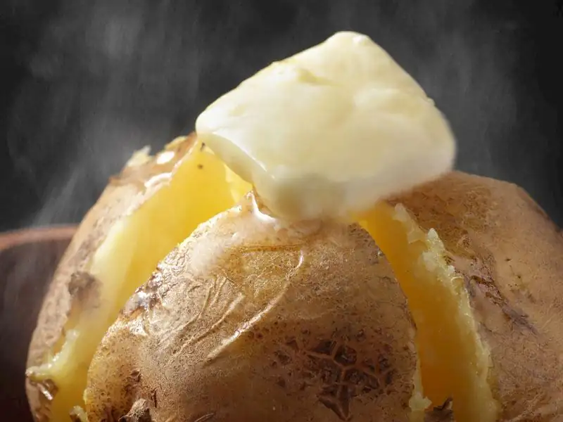 Should potatoes be boiled before making kumpir (baked potato dish)?