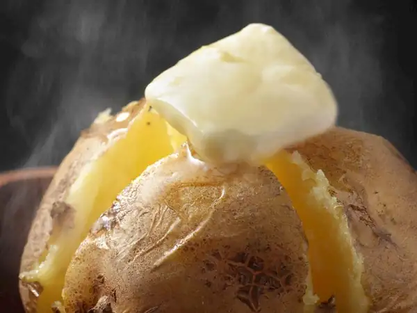 Should potatoes be boiled before making kumpir (baked potato dish)?