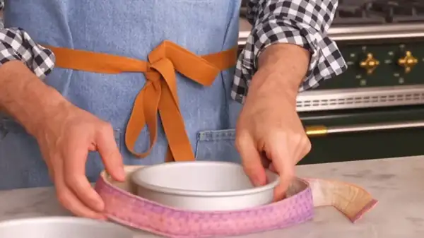 An amateur baker uses a simple trick with aluminum foil to achieve perfectly uniform cakes every time.