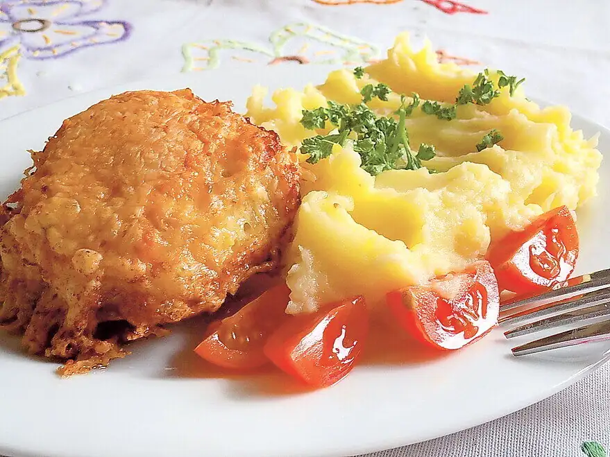 Pollo en queso rallado